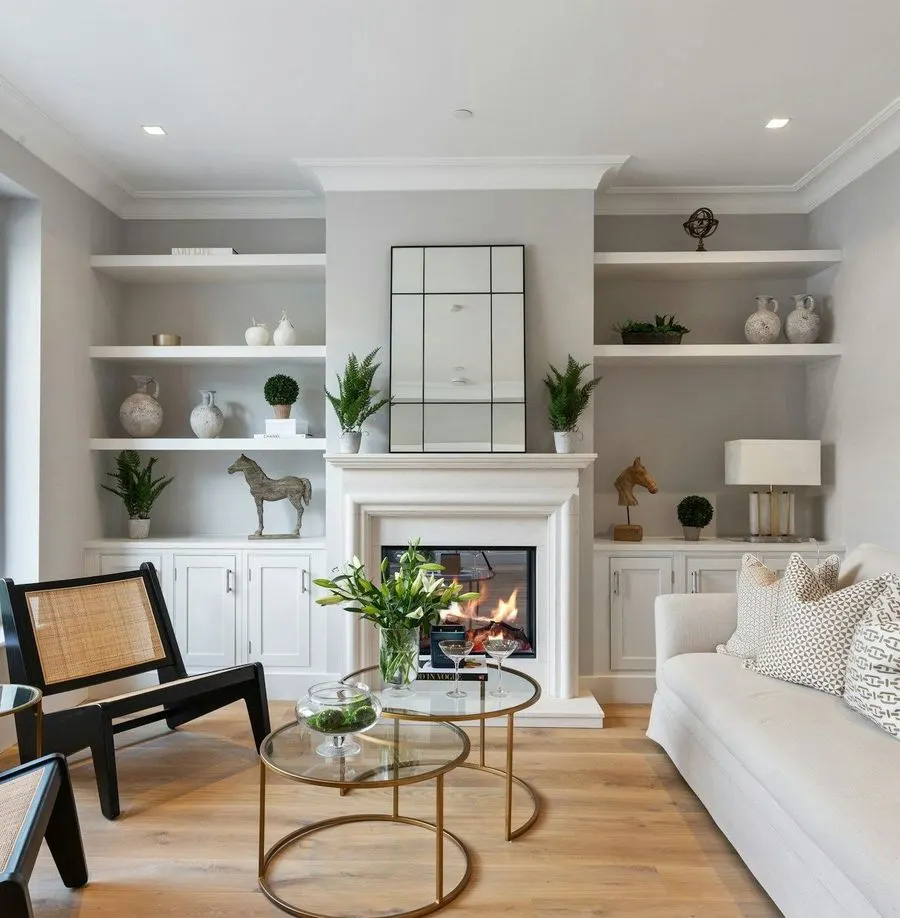 Bright living room with a fireplace and white built-in shelves