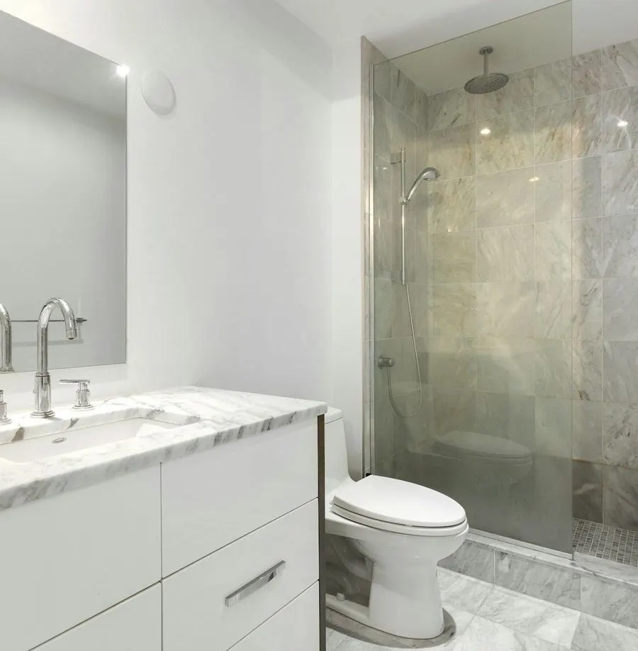 Bathroom with a glass shower and white vanity