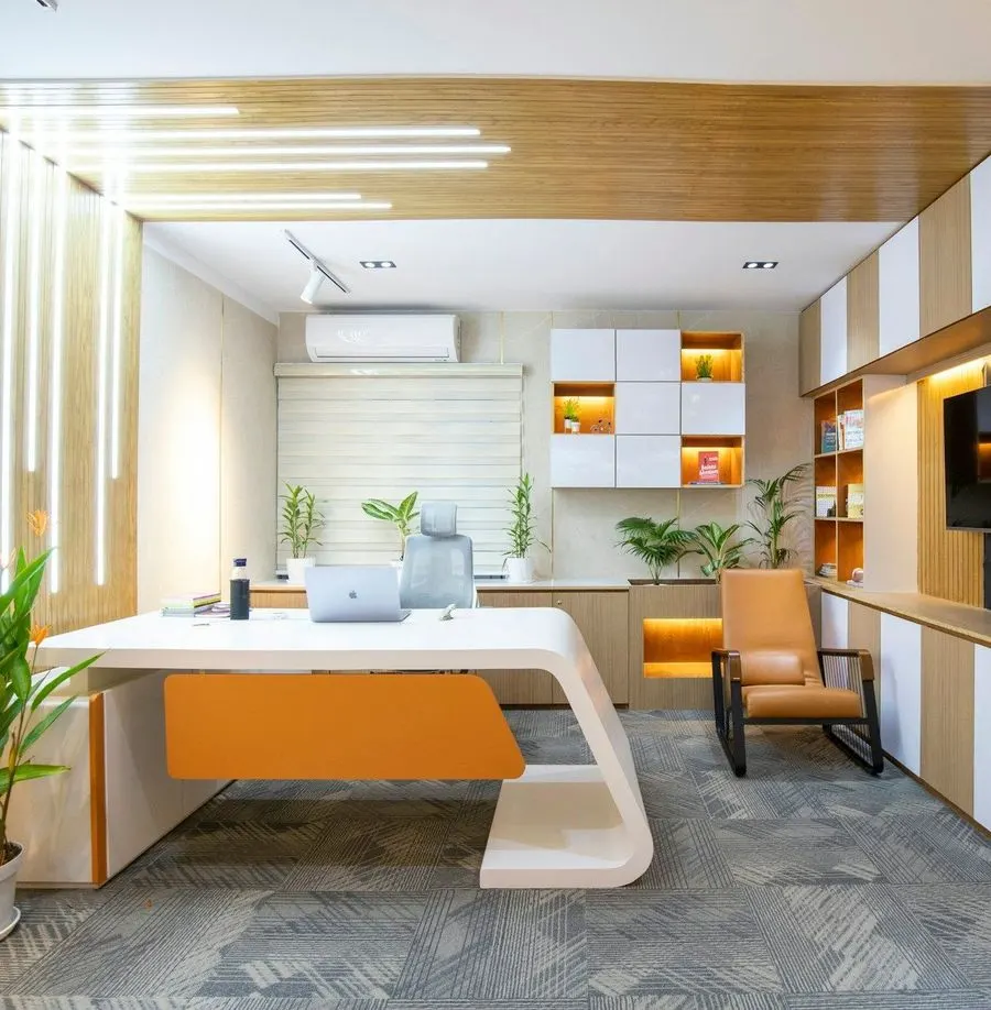 Clean office with a white desk and plants