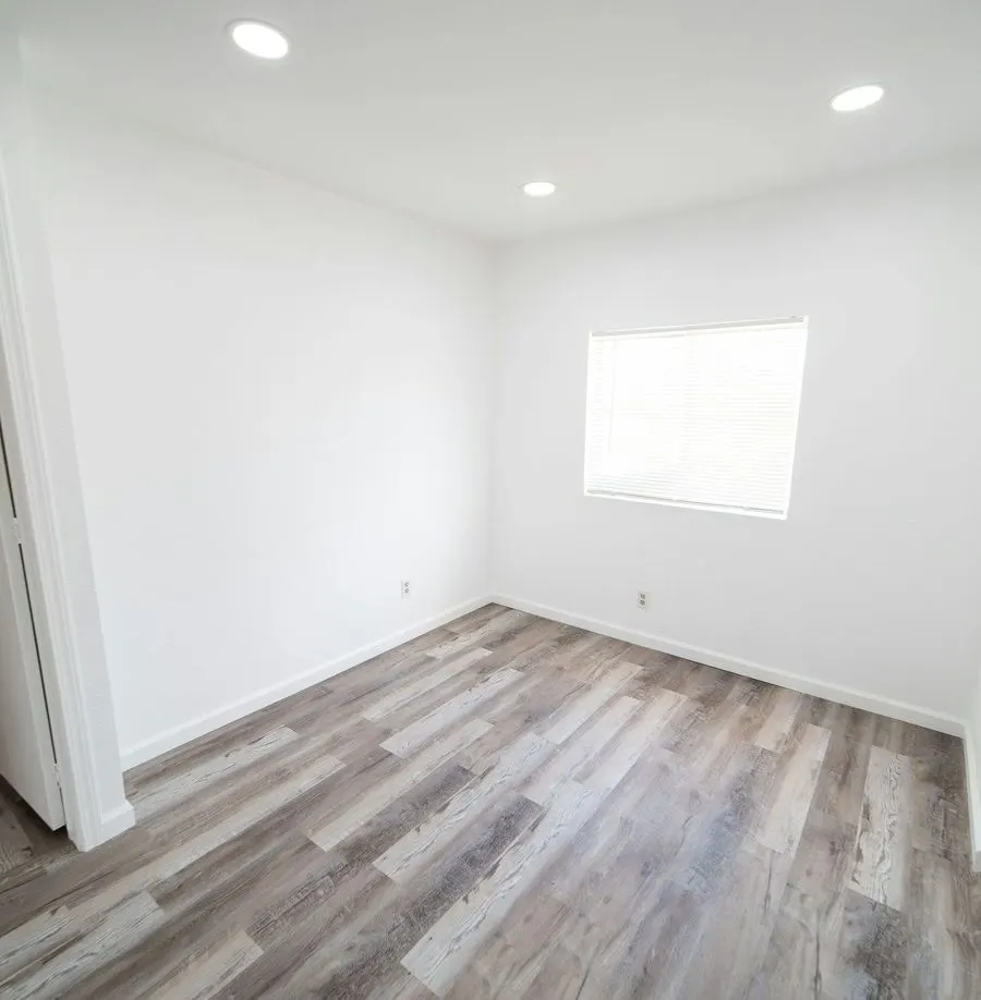 Empty, freshly finished room with wood floors