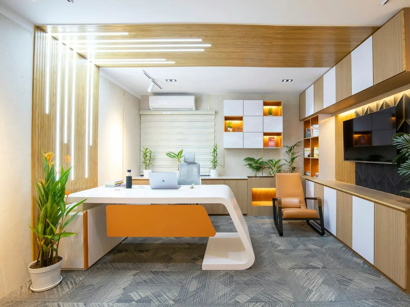 Bright office with a white desk, wood shelving and plants